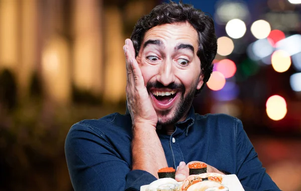 young man eating sushi