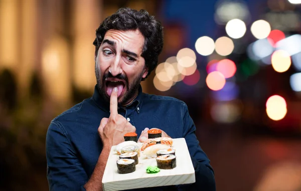 man eating sushi with vomit sign