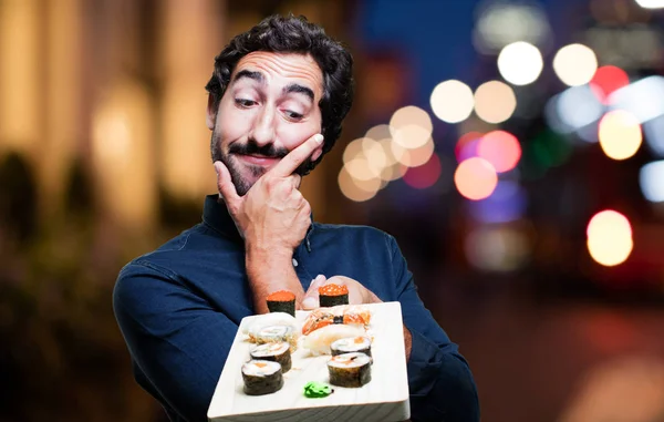 Młody człowiek jedzenie sushi — Zdjęcie stockowe