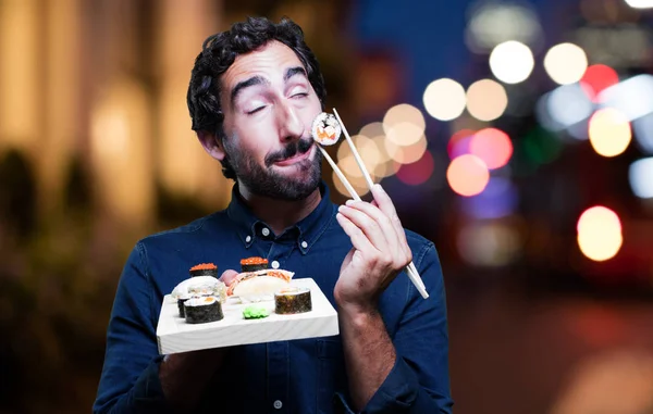 young man eating sushi