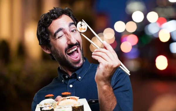 young man eating sushi