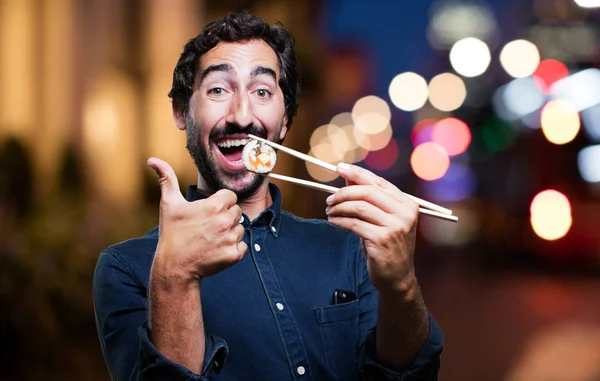 man eating sushi with all right sign