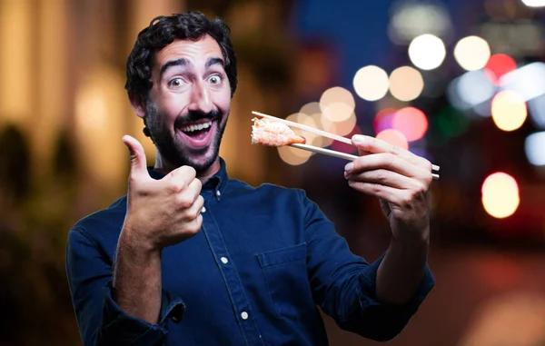 man eating sushi with all right sign