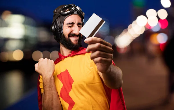 Crazy super hero with credit card — Stock Photo, Image