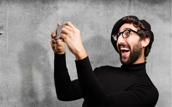 young french artist with mobile phone