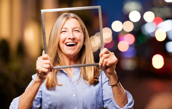 Senior beautiful woman with frame — стоковое фото