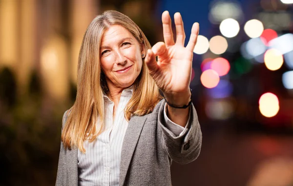 Senior beautiful woman with okay sign — стоковое фото