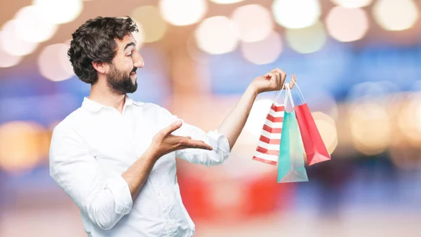 Young funny man with shopping bags — Stock Photo, Image