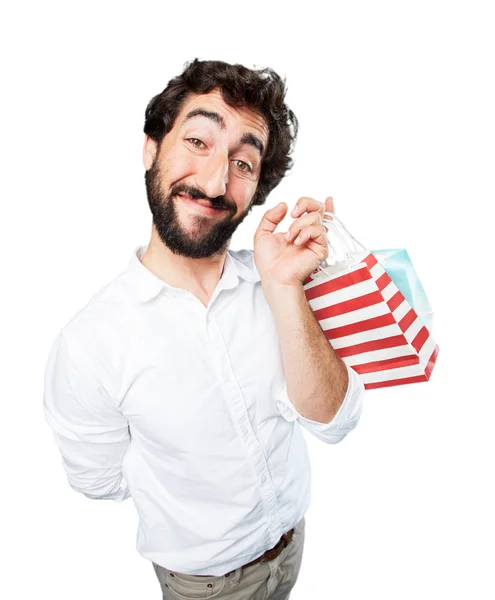 Joven divertido hombre con bolsas de compras — Foto de Stock