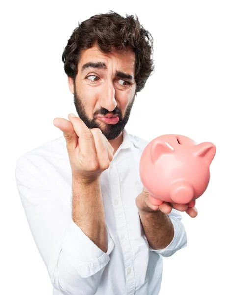 Homem com banco porquinho e expressão triste — Fotografia de Stock
