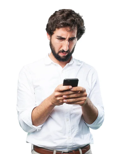 Homem com telefone celular e expressão discordante — Fotografia de Stock