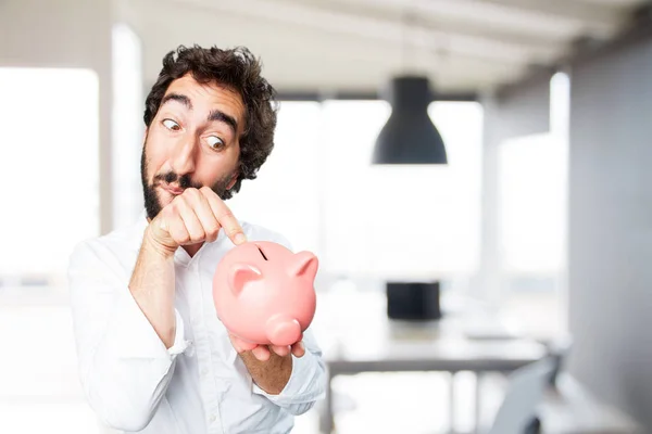 Man with piggy bank and surprise expression — Stock Photo, Image