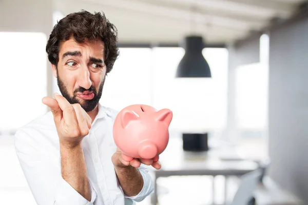 Man with piggy bank and sad expression — Stock Photo, Image
