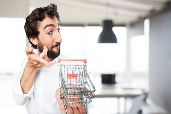 Giovane uomo divertente con carrello della spesa — Foto Stock