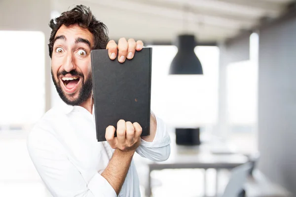 Jovem engraçado homem com um livro — Fotografia de Stock