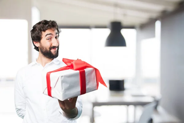 Young funny man with a gift — Stock Photo, Image