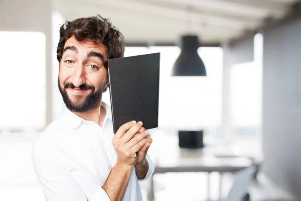 Unga rolig människa med en bok — Stockfoto