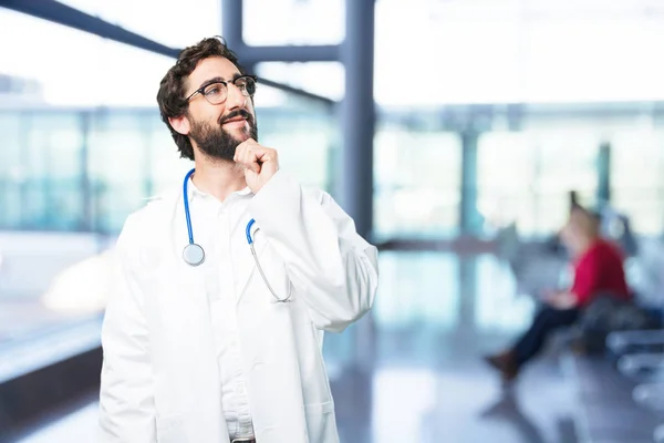 Joven divertido médico pensando —  Fotos de Stock