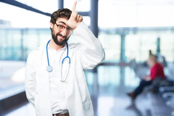 Young funny doctor in loser pose — Stock Photo, Image