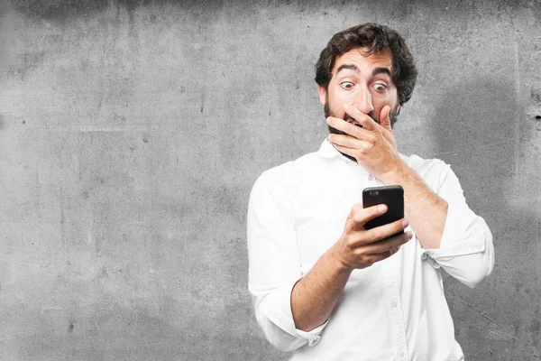 Man with mobile phone and surprise expression — Stock Photo, Image