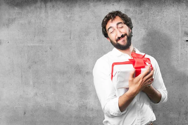 Young funny man with a gift — Stock Photo, Image
