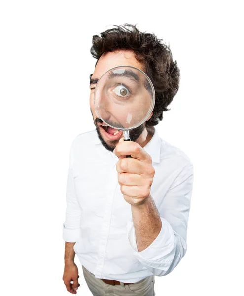 Man with magnifying glass and surprise expression Stock Picture