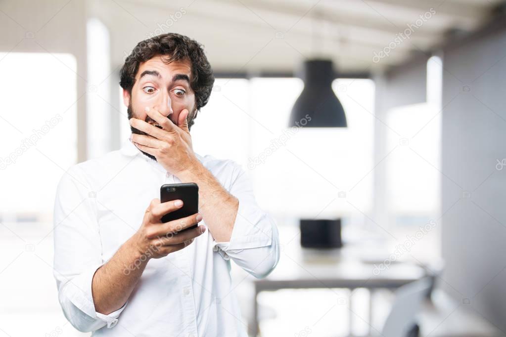 man with mobile phone and surprise expression