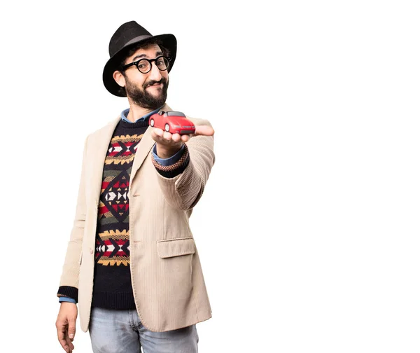 Young cool hipster with a red car — Stock Photo, Image