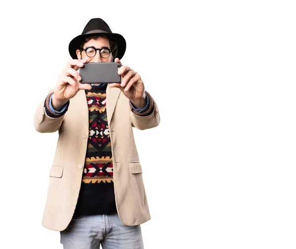 Young cool hipster with a mobile phone — Stock Photo, Image