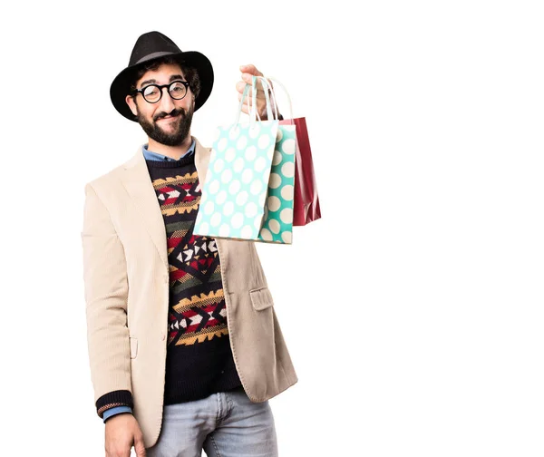 Jonge coole hipster met shopping tassen — Stockfoto