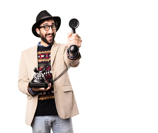 Young cool hipster with a vintage phone — Stock Photo, Image