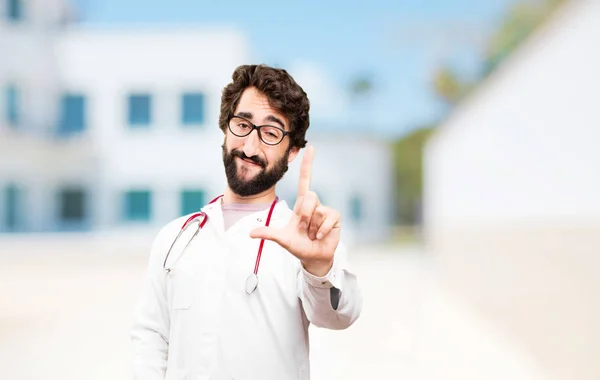 Young doctor man with loser sign — Stock Photo, Image