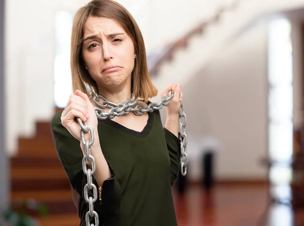 Sad young pretty woman with a chain — Stock Photo, Image