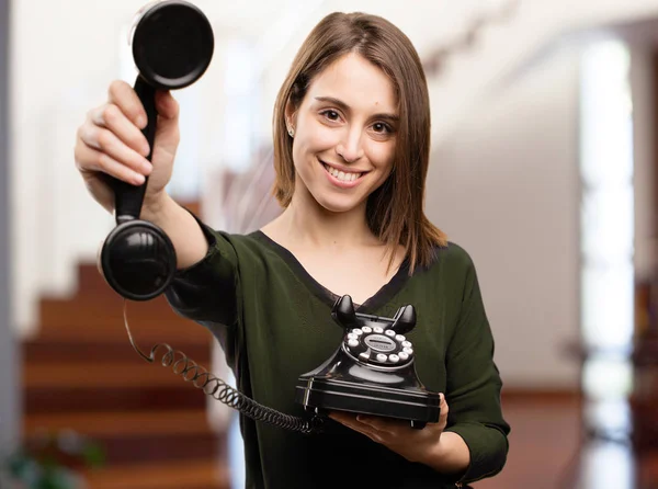 Young pretty woman with old phone — Stock Photo, Image