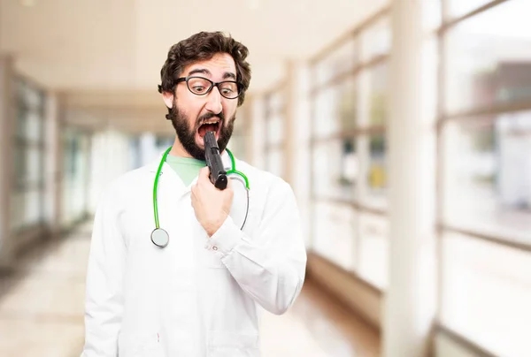 Young doctor man with a gun — Stock Photo, Image
