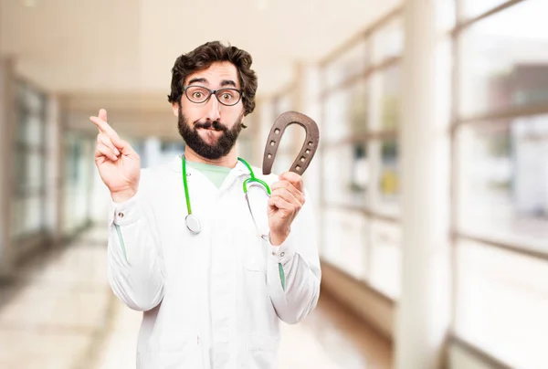 Young doctor man with horseshoe — Stock Photo, Image