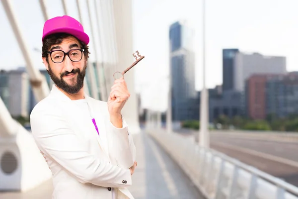 Young crazy businessman with old key — Stock Photo, Image