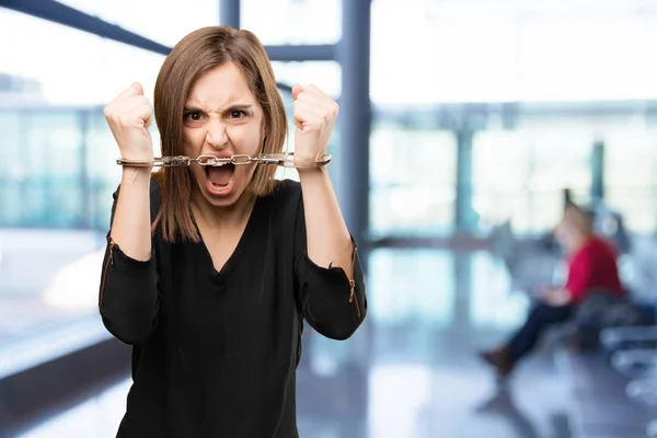 Angry pretty woman with handcuffs — Stock Photo, Image