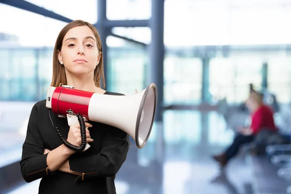 Angry young pretty woman with megaphone — Stock Photo, Image
