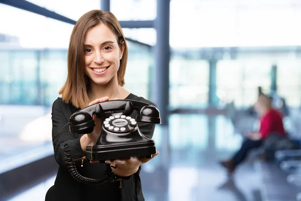 Young pretty woman with old phone — Stock Photo, Image