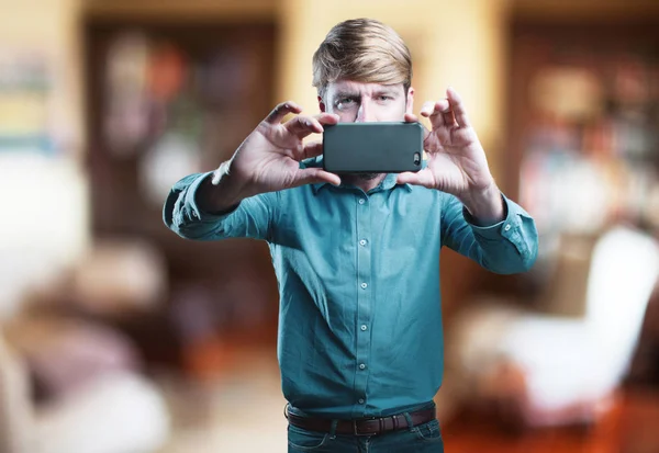 Jeune homme blond avec téléphone portable — Photo