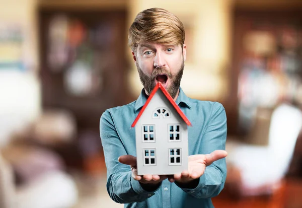 Young blonde man with a house — Stock Photo, Image
