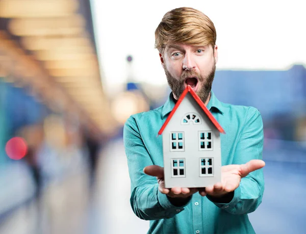 Young blonde man with a house — Stock Photo, Image