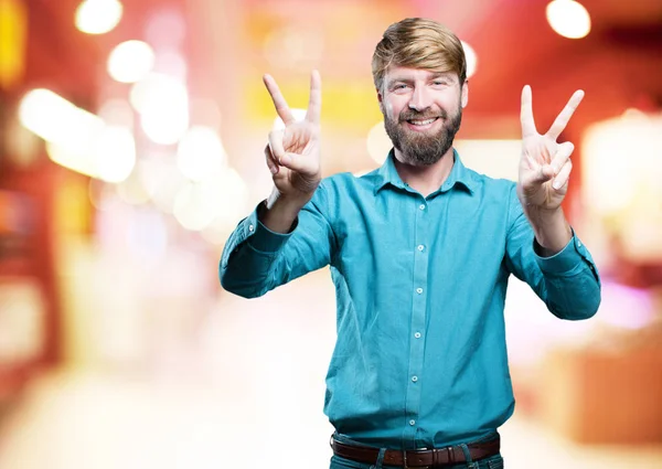 Young blonde man with victory sign — Stock Photo, Image
