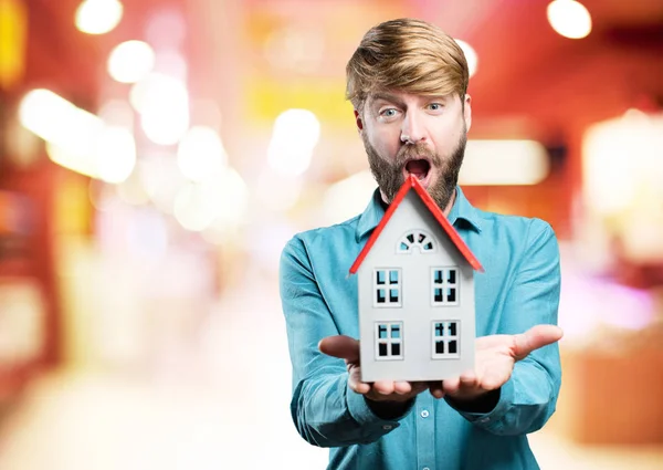 Junger blonder Mann mit einem Haus — Stockfoto