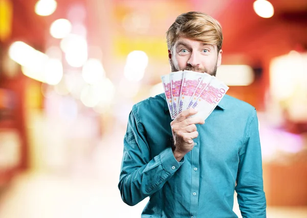 Young blonde man with bills — Stock Photo, Image