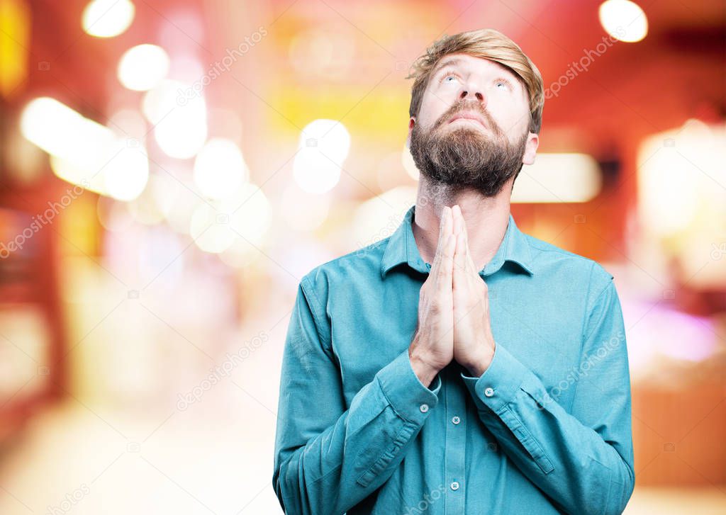young blonde man praying