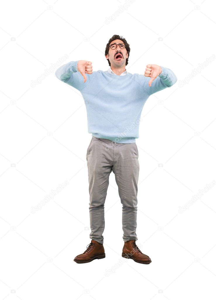 Young crazy man with angry expression. Full body cutout person against white background.