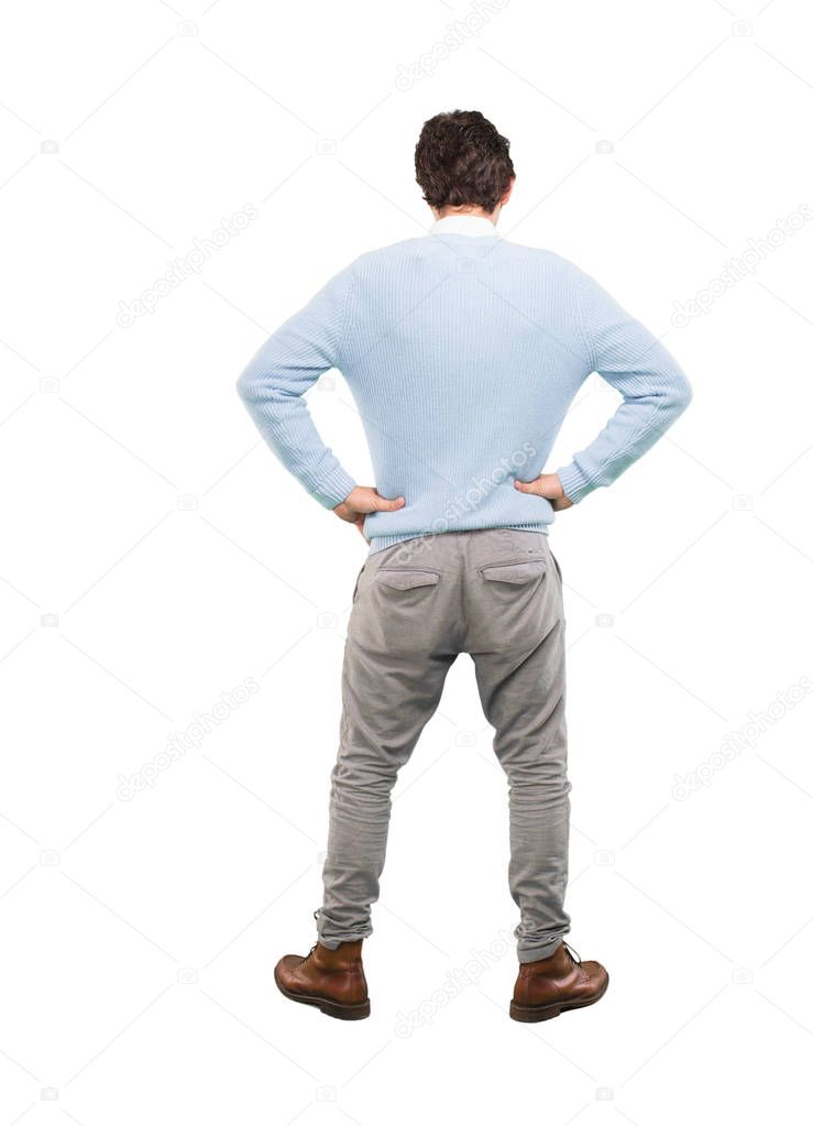 Young crazy man facing to a challenge with proud pose. Full body cutout person against white background.