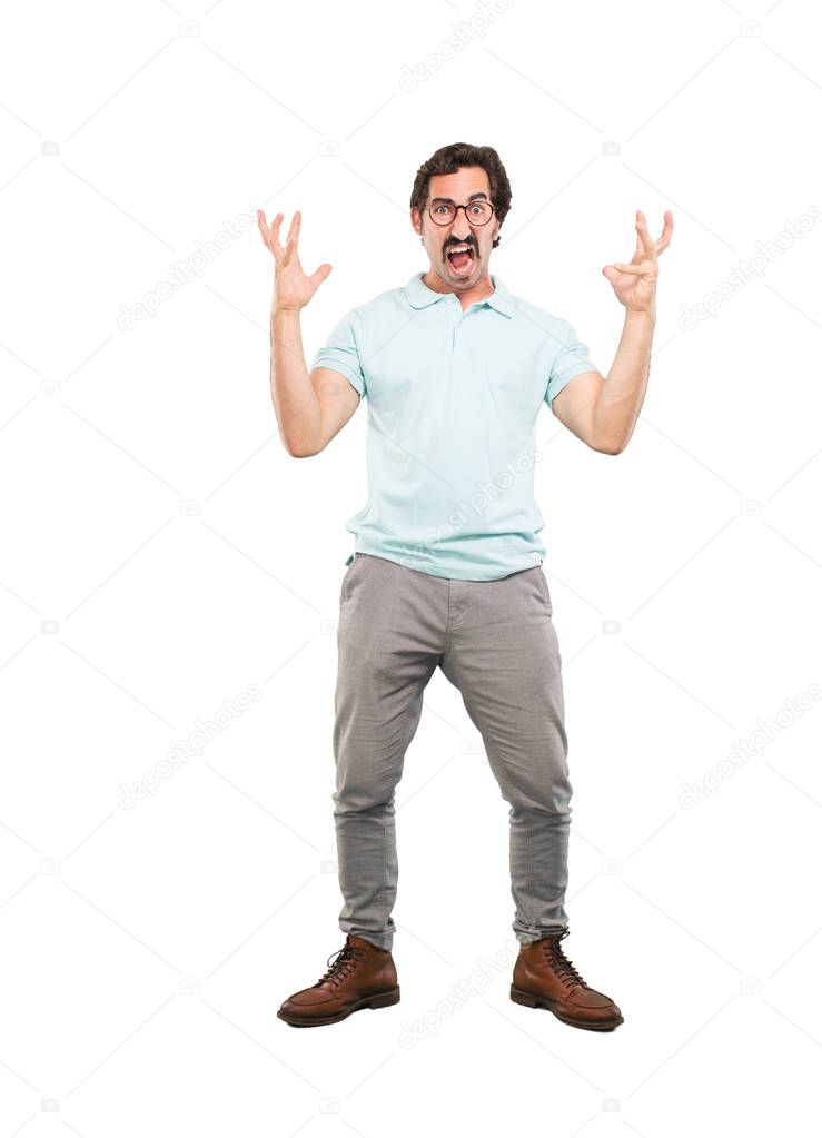 Young crazy man with angry expression. Full body cutout person against white background.